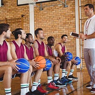 Basketball coach talking to her players